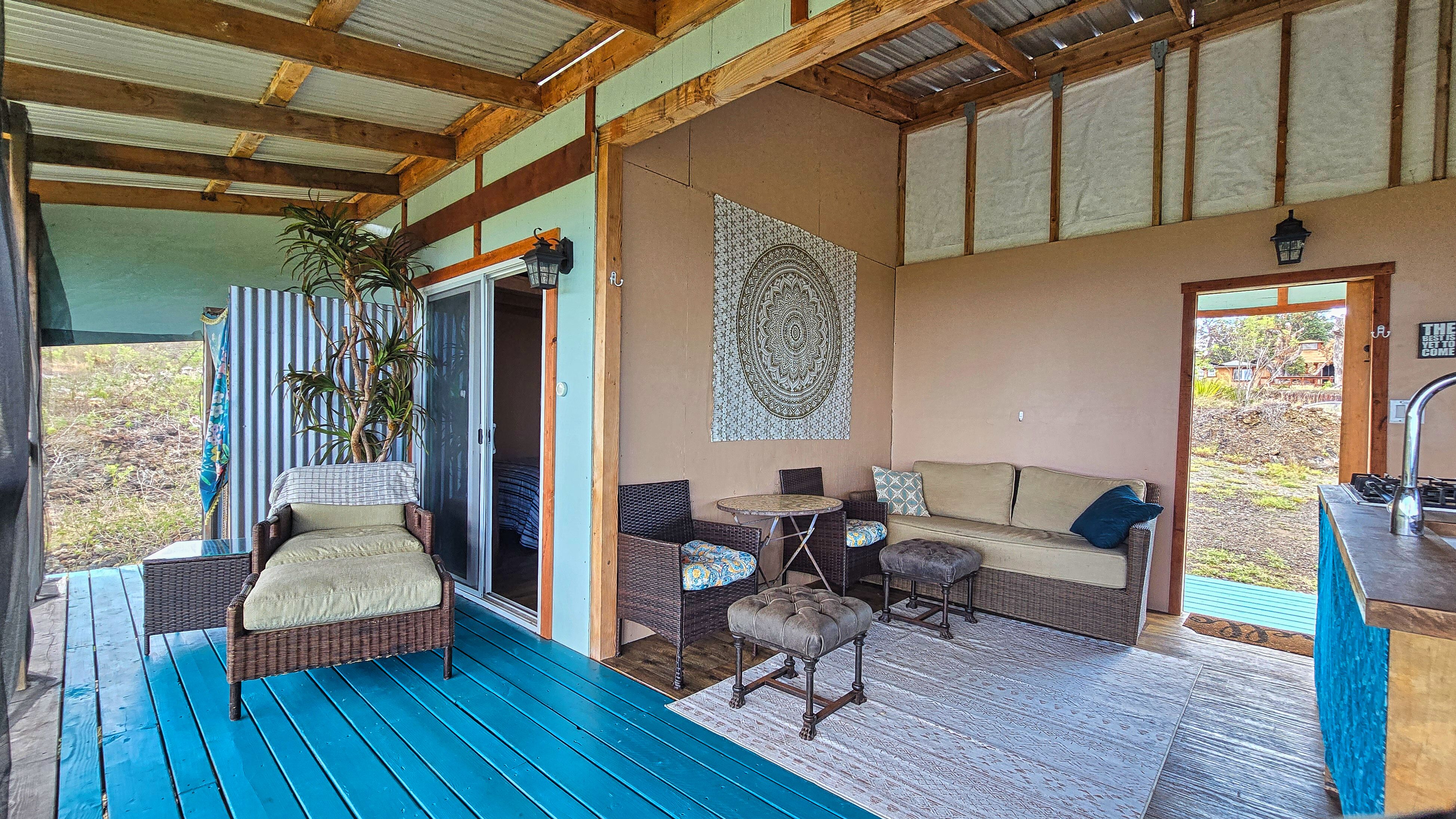 Open-air living room with relaxed seating and natural flow to the outdoors—enjoy ocean views and indoor-outdoor island living on Hawai‘i Island.