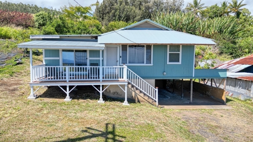 Front view of beautifully renovated 3-bedroom, 1-bath home with stunning ocean views from many rooms.