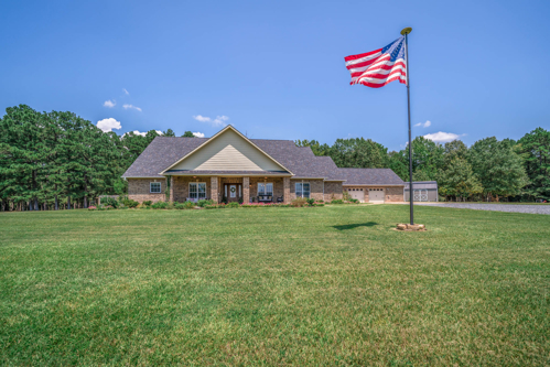 East Texas country home for sale near Atlanta TX with custom wood doors and tile entryway.