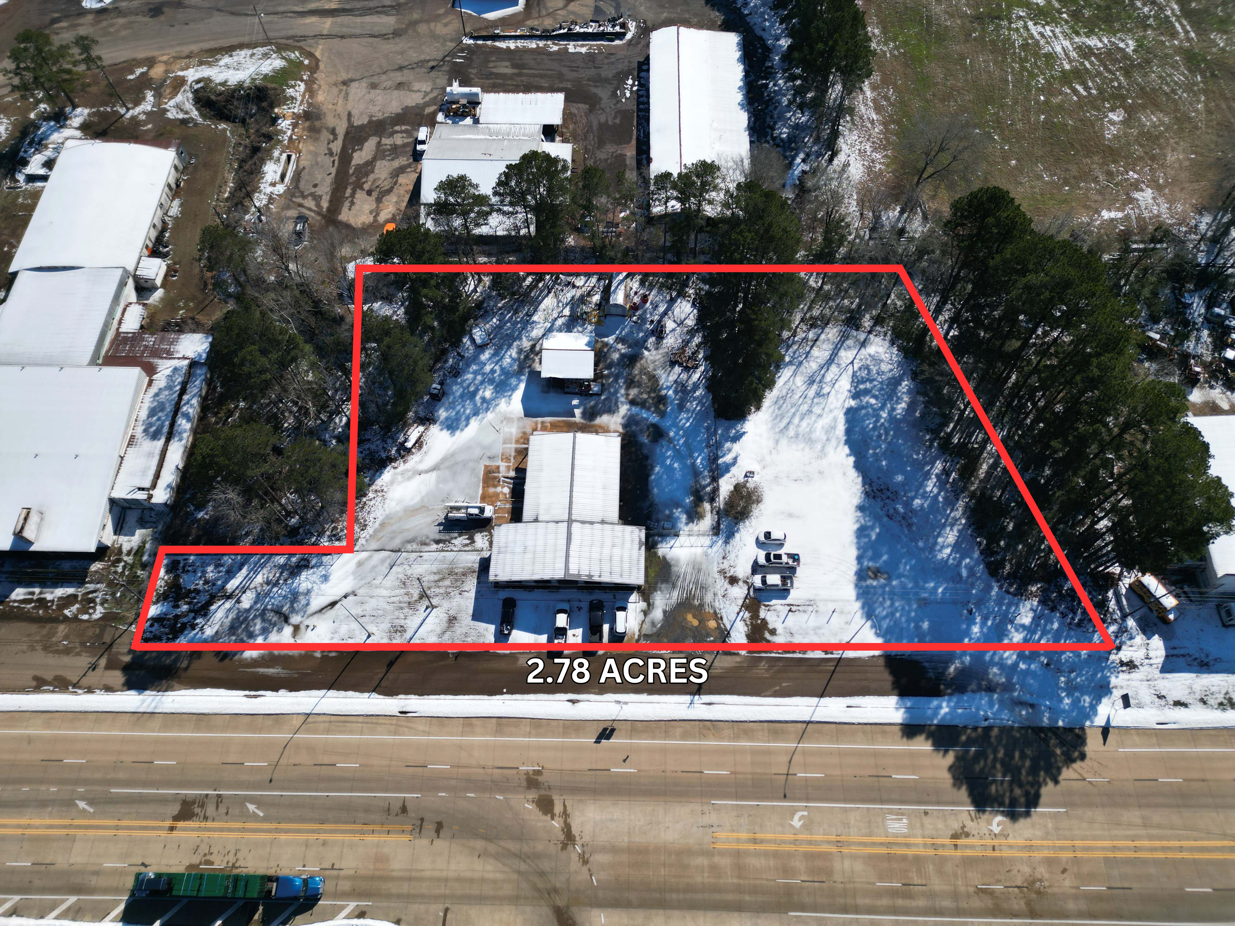 Aerial view showing full 2.78‑acre commercial property boundaries along Hwy 59 in Atlanta TX.