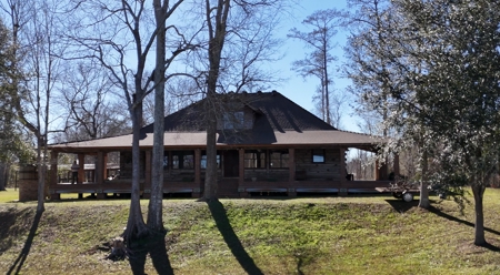 A Rare Riverfront Log Cabin Retreat in Butte La Rose - image 1