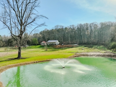Creekfront Land for Sale in Tennessee with Pond, Shop, and Cabins - image 1