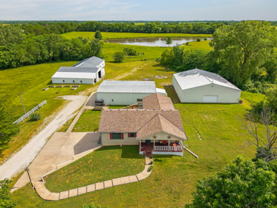 Country Home with Acreage and Shop Buildings Near KC - image 1
