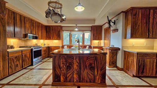 Brazillian wood floors are inlaid along side travertine tile which make this area pop.