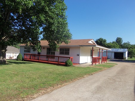East Side View With Shop In Background